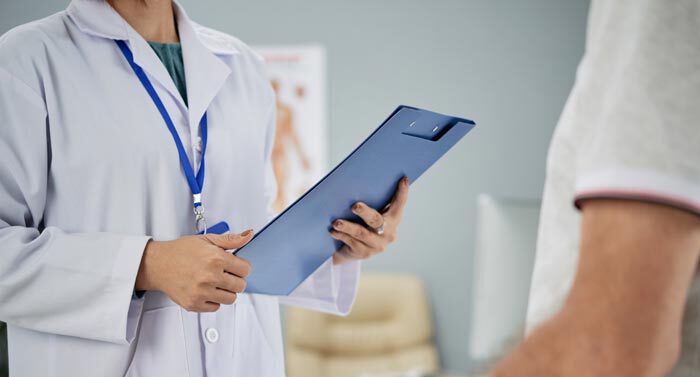 Un doctor realizando un test de estado mental a un paciente para realizarse una cirugía estética